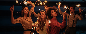 party-goers dance with sparklers
